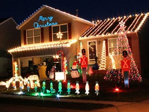 A photo of a home thoroughly decorated with Christmas lights from GoodHousekeeping.com