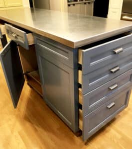 A kitchen island painted by NE Portland Painters, in a medium gray color